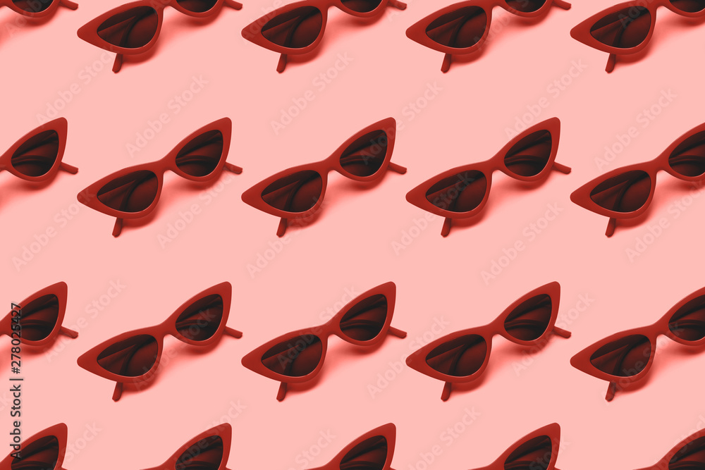 Red sunglasses pattern on blue background. Flat lay. Summer concept. From top view. Red sunglasses pattern on blue background. Flat lay. Summer concept. From top view.