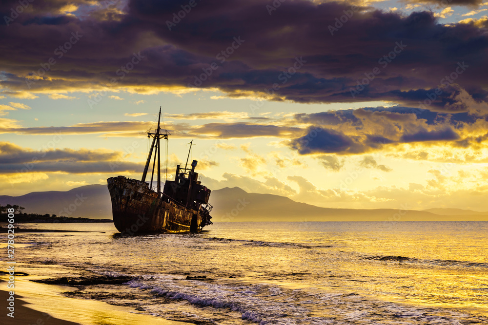 Rusty broken shipwreck on sea shore Rusty broken shipwreck on sea shore