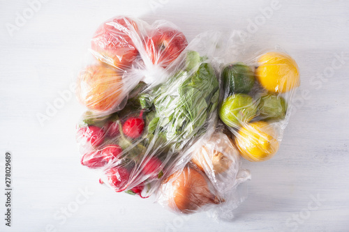 single use plastic packaging issue. fruits and vegetables in plastic bags photo