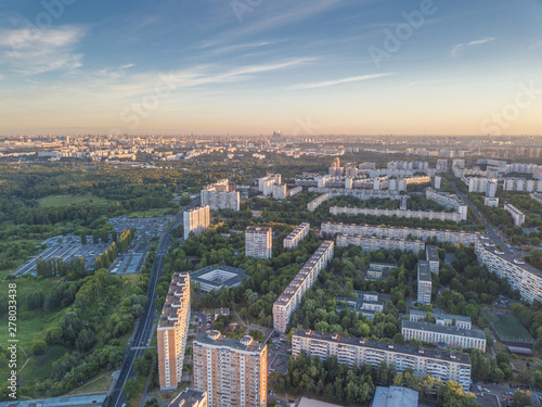 Wallpaper Mural Aerial view of the city district with tall residential buildings, roads and highways, park zones and yards with green trees. Summer urban landscape under сlear sky at sunrise. Moscow city, Russia Torontodigital.ca