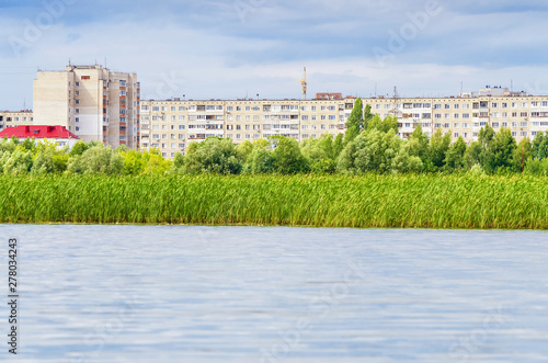 Residential area in Dimitrovgrad, Russia, view from the Big Cheremshan river. Cloudy weather photo