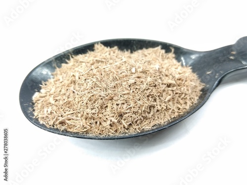 A picture of wood powder on black spoon