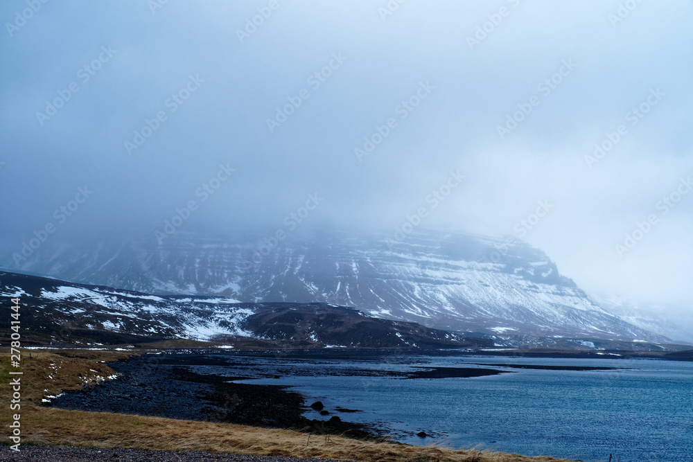 Surrounding of Kirkjufell mountain in Iceland with mystical cloudy atmosphere