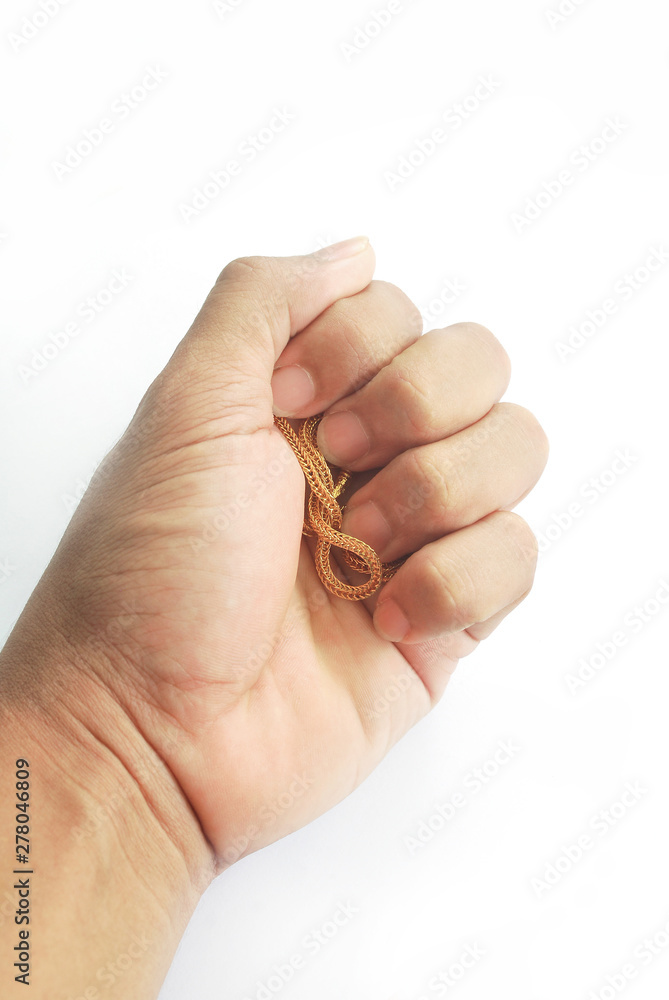 The Asian male hand is holding a gold ring on a white background.