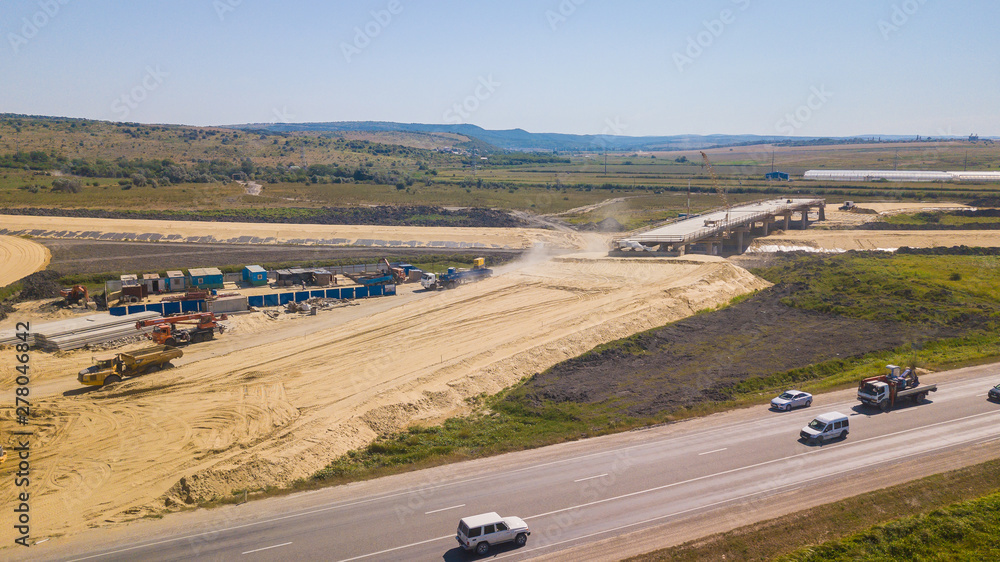 Aerial Road Building Site. Flight Over Construction Crews And Heavy Equipment