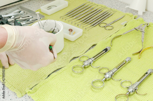 Medical equipment preparation for dental surgery probes files syringes on table photo