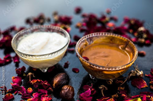 Nutmeg face mask to treat to even out discolorations and pigmentation on your face on the wooden surface consisting of Nutmeg powder, lemon juice, and curd. photo