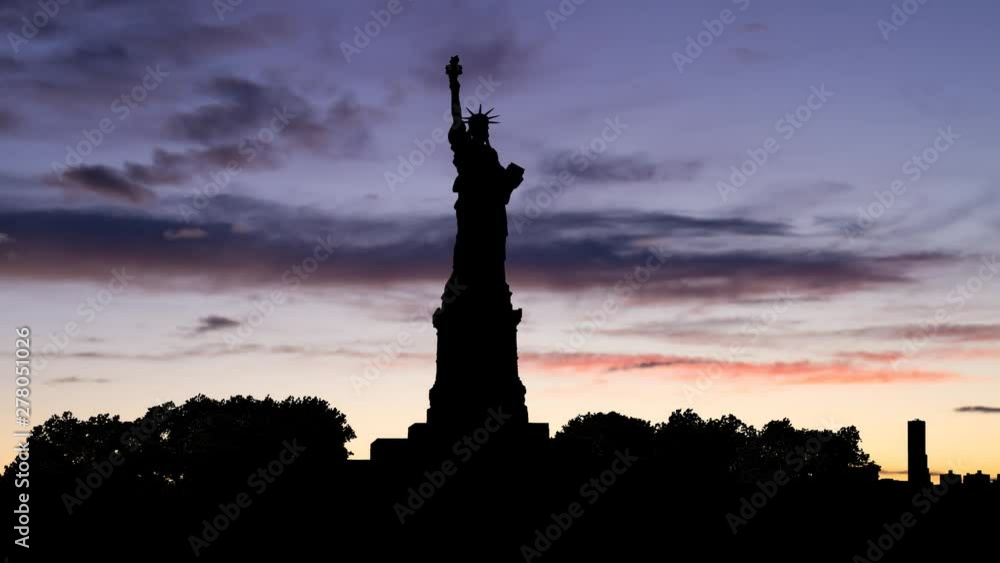 The Statue of Liberty in Silhouette, Time Lapse at Twilight, New York City, USA The Statue of Liberty in Silhouette, Time Lapse at Twilight, New York City, USA
