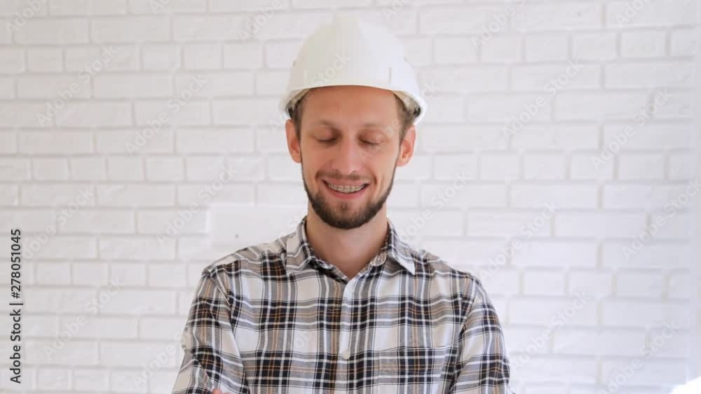 Engineer in hardhat gestures thumb up and ok. Engineer in hardhat gestures thumb up and ok.