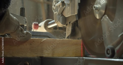 Close-up shot headsaw carving the wood into small squares at manufacture. photo