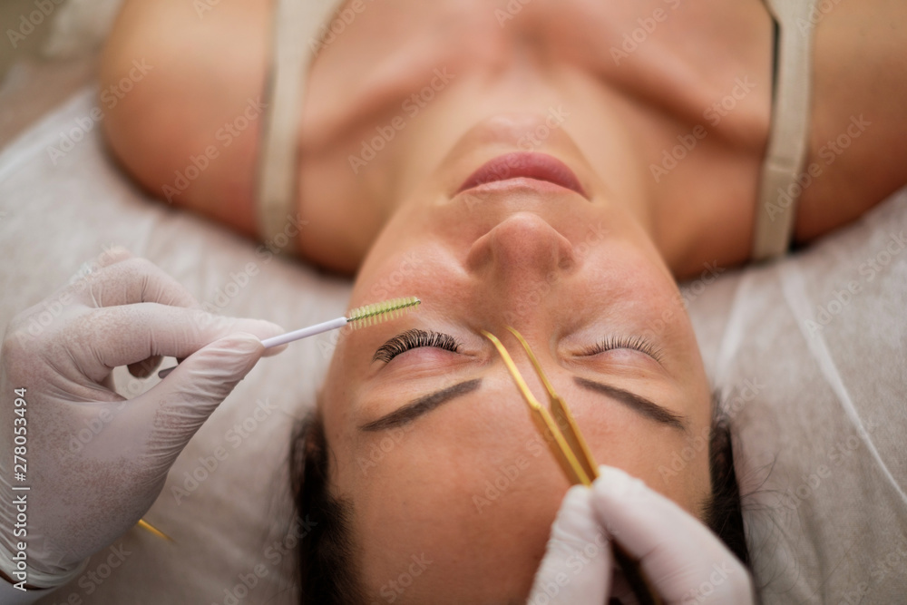 Procedure of eyelash extension in salon by cosmetician Procedure of eyelash extension in salon by cosmetician