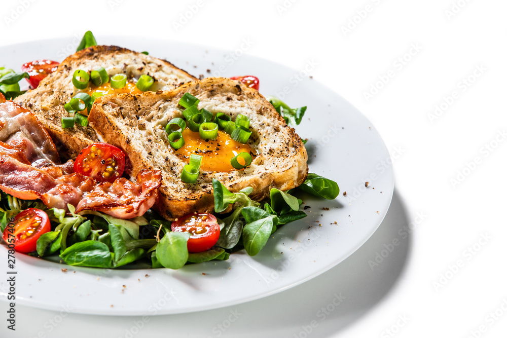 Breakfast - toasted bread with fried egg, bacon and vegetables