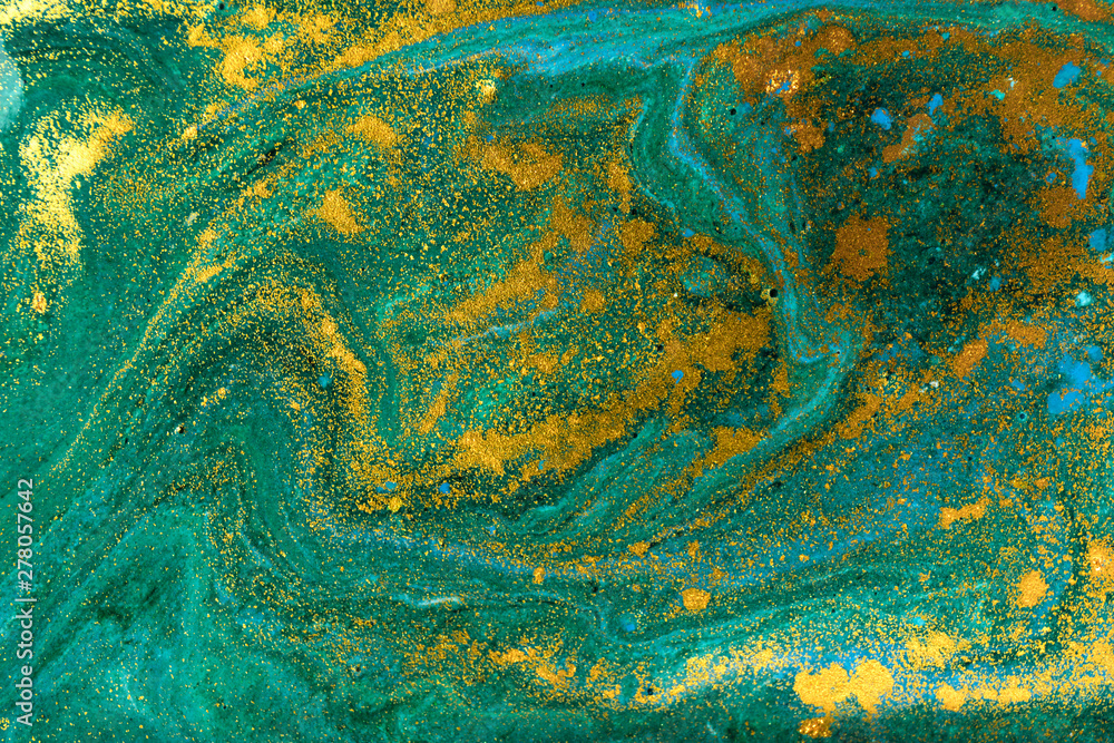 Liquid uneven green marbling pattern with golden glitter and glare of light Liquid uneven green marbling pattern with golden glitter and glare of light