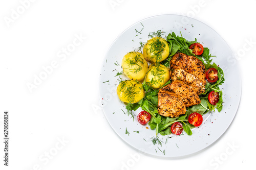 Grilled chicken fillet and vegetables on white plate