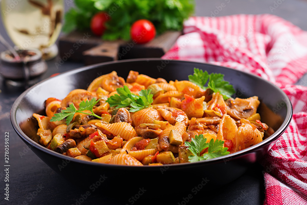 Conchiglie pasta. Italian pasta shells with mushrooms, zucchini and tomato sauce.