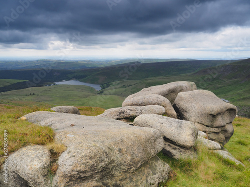 Overlooking Kinder Reservoir walking along the Pennine Way with dark storm clouds overhead, Peak District National Park, UK