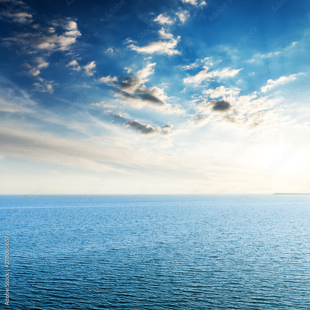 sunset in clouds over blue sea. Aerial view sunset in clouds over blue sea. Aerial view