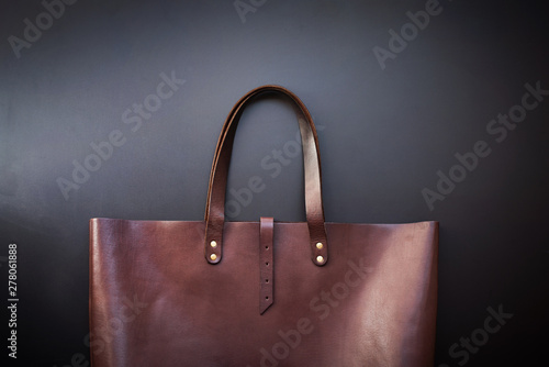 Elegant luxury leather brown bag dark background © olga pink