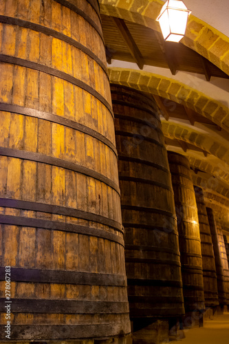 Vintage wine cellar with old oak barrels, production of fortified dry or sweet marsala wine in Marsala, Sicily, Italy