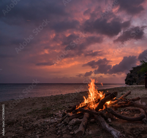 Fototapeta Naklejka Na Ścianę i Meble -  A fantastic sunset at the beach with a bonfire and BBQ on the island of Curacaio