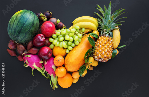 Set fresh organic exotic tropical fruit on dark