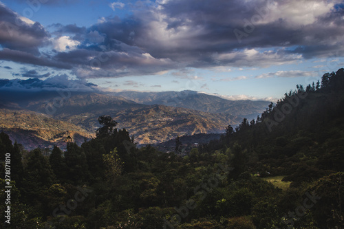 Waning sunlight over the Cundinamarca Valley near Bogotá, capital city of Colombia. Pine trees and evergreens grows over the mountainside