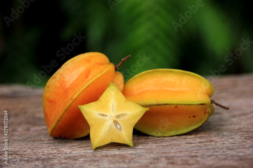 Carambola or star apple ( starfruit ) on old wooden background,Close up healthy carambola or star apple food . 