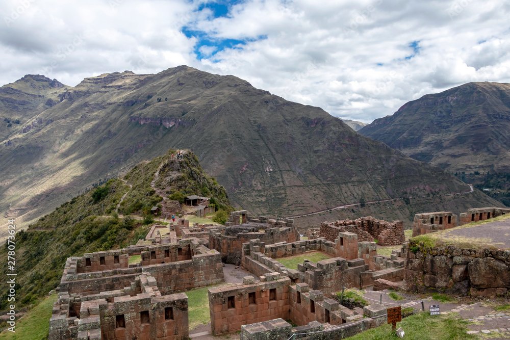 Inca ruins in Pisac archeological site surrounded by green peruvian Andes mountains, Sacred valley of the Incas, Peru