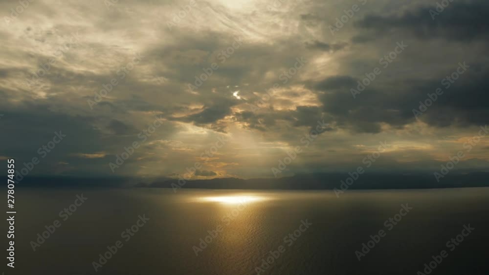 Sunset above the sea surface with waves, top view. Reflected sun on a water surface. Sunset over ocean. Seascape, Summer and travel vacation concept Sunset above the sea surface with waves, top view. Reflected sun on a water surface. Sunset over ocean. Seascape, Summer and travel vacation concept