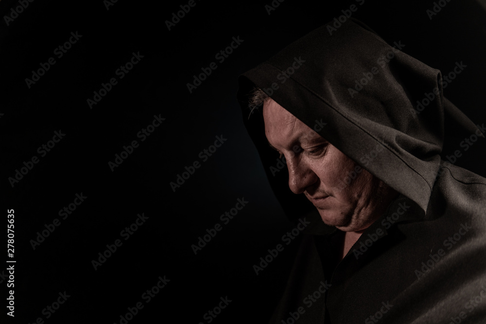 Portrait of a courageous warrior wanderer in a black cloak. Historical fantasy. Halloween. Portrait of a courageous warrior wanderer in a black cloak. Historical fantasy. Halloween.