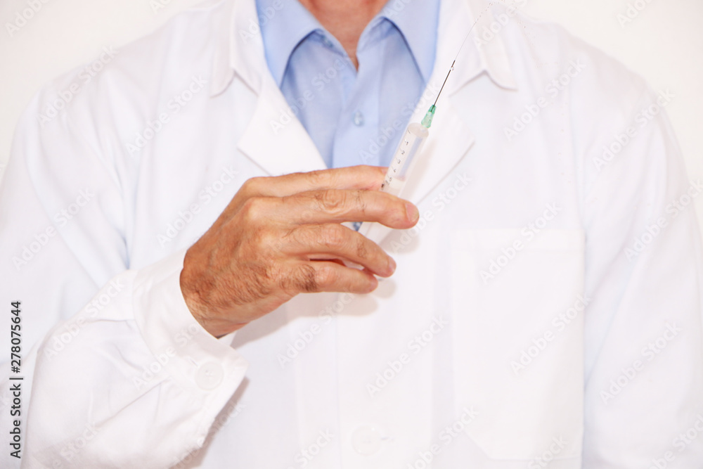 Doctor holds a syringe for vaccination Doctor holds a syringe for vaccination