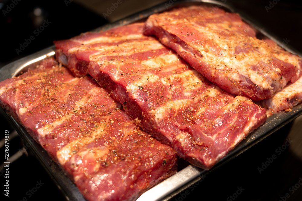 Pieces of ribs are on a tray