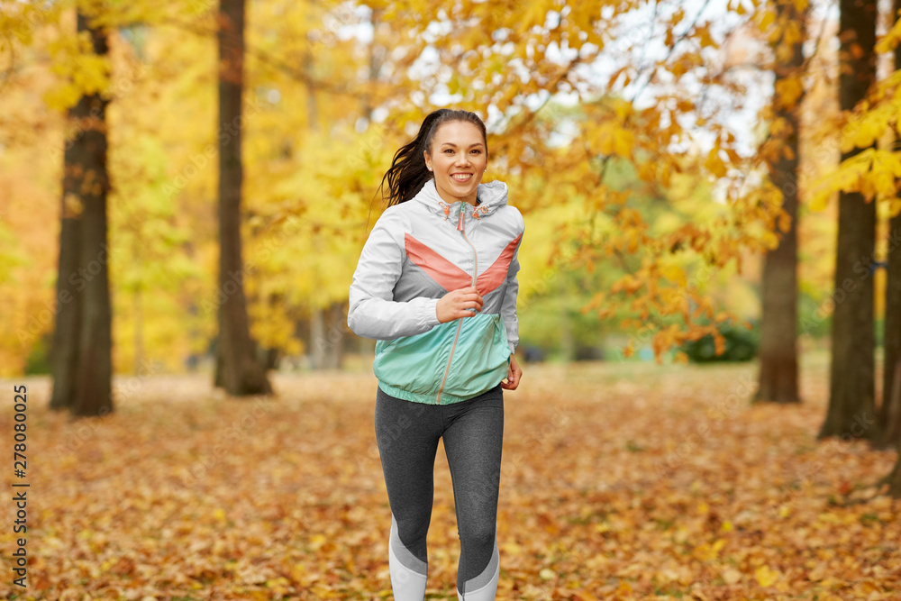 fitness, sport, people and healthy lifestyle concept - young woman running in autumn park fitness, sport, people and healthy lifestyle concept - young woman running in autumn park