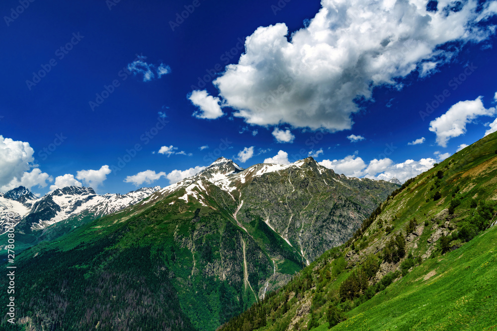 Mountain panorama in clouds. Caucasus, region Dombay.