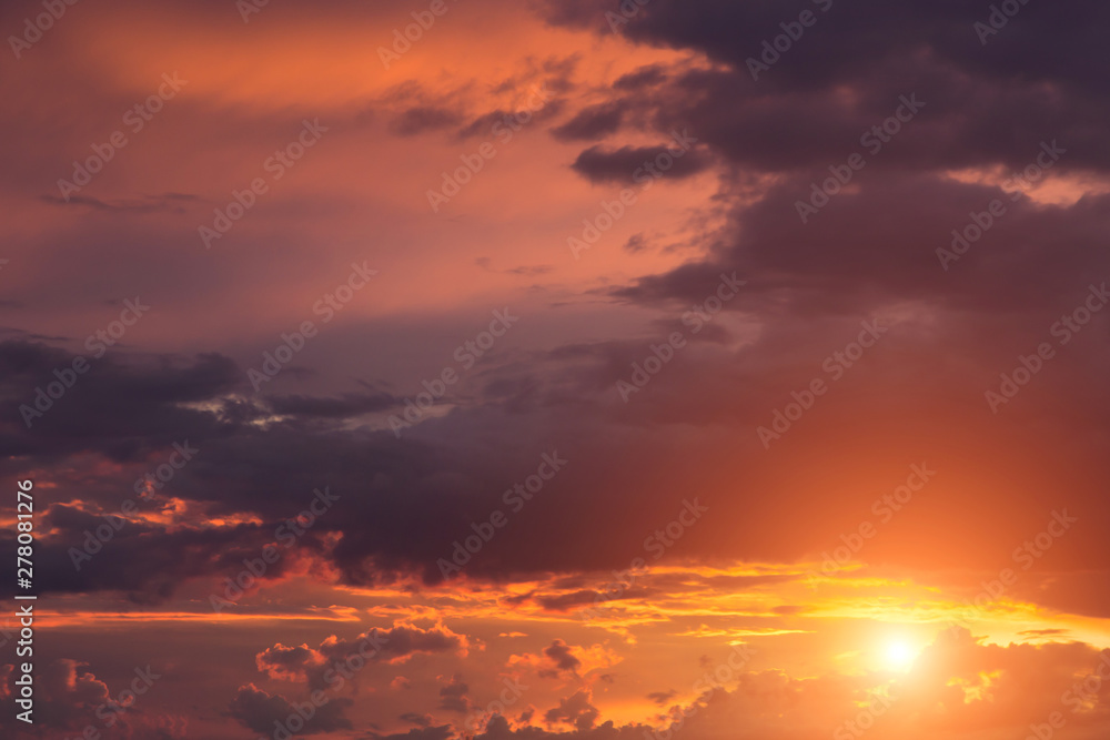Beautiful epic sunset orange pink sky with clouds, sun, sunlight