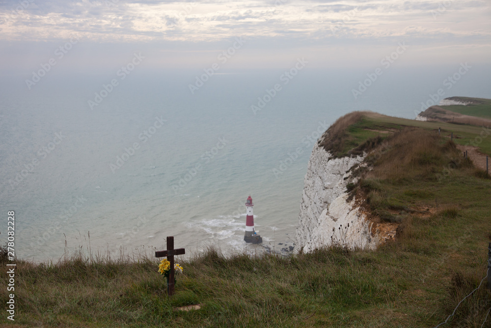 White chalk cliffs and Beachy Head Lighthouse. Eastbourne, East Sussex, England. Highest chalk sea cliff in Britain, rising to 162 metres. Third most common suicide spot in the world