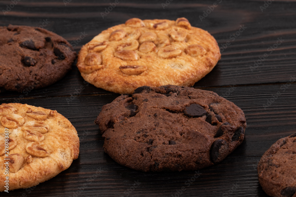 Chocolate cookies on wooden table. Homemade food on wooden background Chocolate cookies on wooden table. Homemade food on wooden background