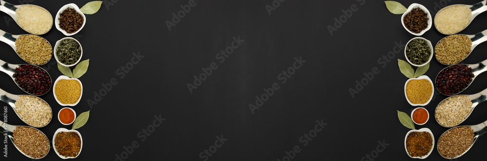 BEANS RICE BUCKWHEAT SEEDS LENTILS SPICES IN SPOONS ON A BLACK BACKGROUND BEANS RICE BUCKWHEAT SEEDS LENTILS SPICES IN SPOONS ON A BLACK BACKGROUND