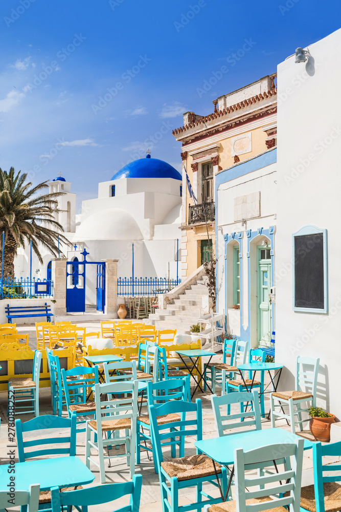 Fototapeta premium Traditional greek street with cafe tables in Serifos island, Cyclades, Greece 