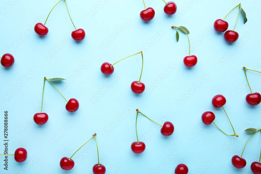 Cherry pattern. Flat lay of cherries on a blue background.Top view Cherry pattern. Flat lay of cherries on a blue background.Top view
