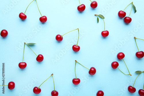 Cherry pattern. Flat lay of cherries on a blue background.Top view