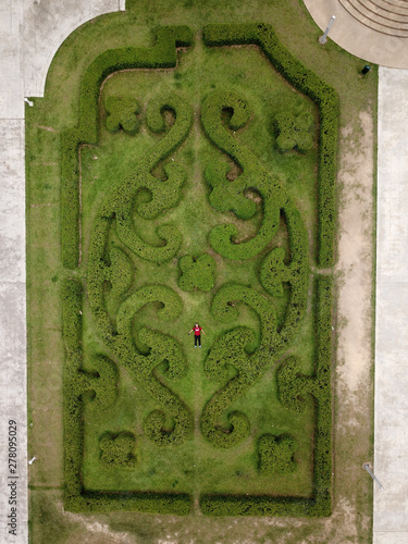 Aerial view of person in center of hedge maze