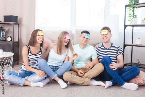 Group of young people playing games indoors. Active youth. Happy smiling people having fun. Students at the holidays.