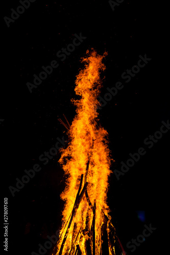 The big tall fire that burns at night On a black background.
