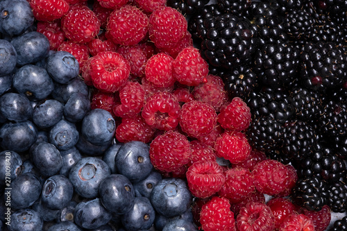 Mix berries and fruits. The view from the top. Background berries are diagonally Black-blue and red food.