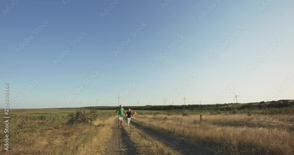 Children running over the camera in field Children running over the camera in field