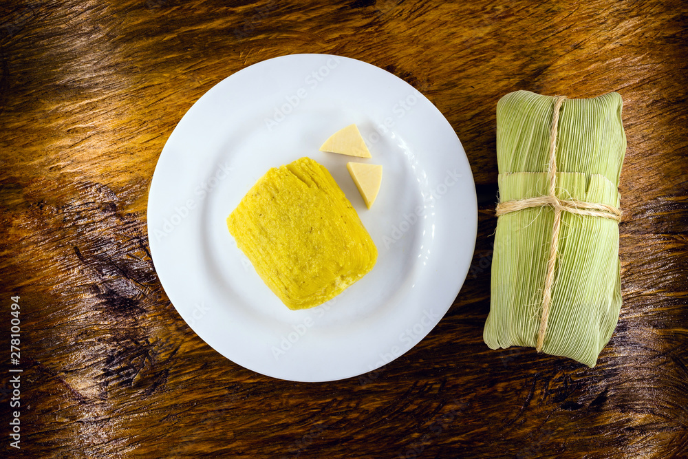 pamonha, Brazilian sweet made from homemade cheese with corn. Open pissing ready for consumption. Concept of traditional Brazilian sweet, typical food of the months of June and July. pamonha, Brazilian sweet made from homemade cheese with corn. Open pissing ready for consumption. Concept of traditional Brazilian sweet, typical food of the months of June and July.