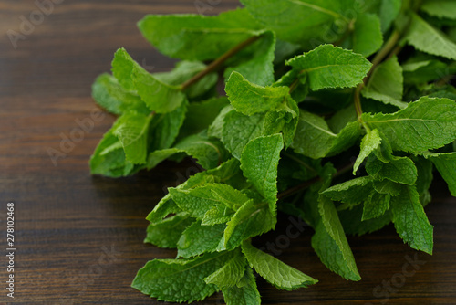Freshly harvested organic mint on a wooden table