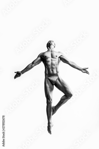 Dance freedom concept. Young handsome ballet man in fly grace pose. Perfect hair   skin. Close up. Studio shot