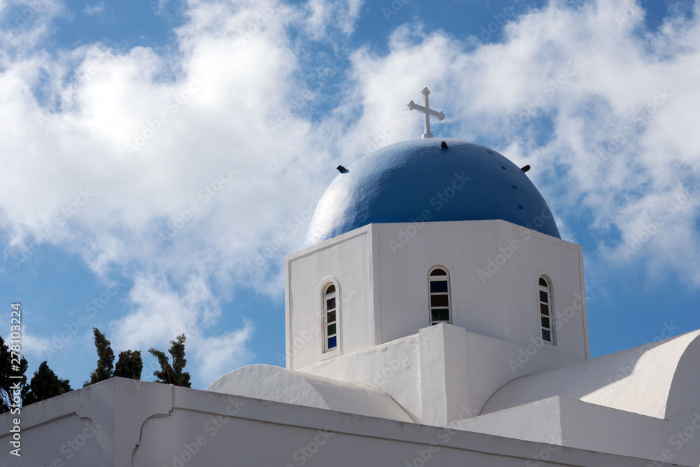 Beautiful island of Santorini, Greece. White Church with a blue dome in the village of Oia on the island of Santorini. Greek journey. The famous blue domes of Santorini.